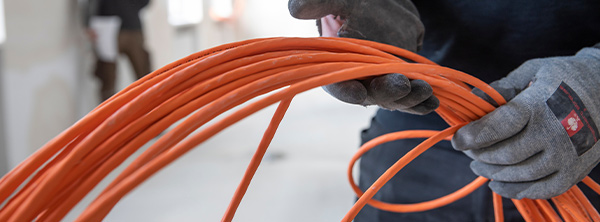An electrician holding a reel of wires