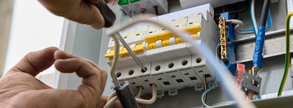 An electrician installing a fuse box